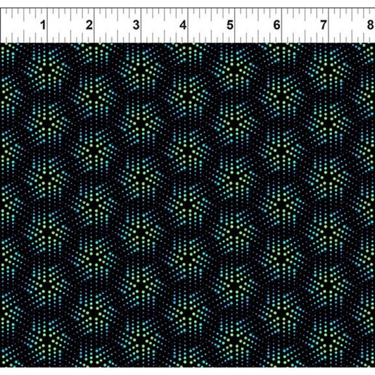 Grid pattern of playful geometric pinwheels comprised of tiny blue and green dots on a black background. Ruler for scale.