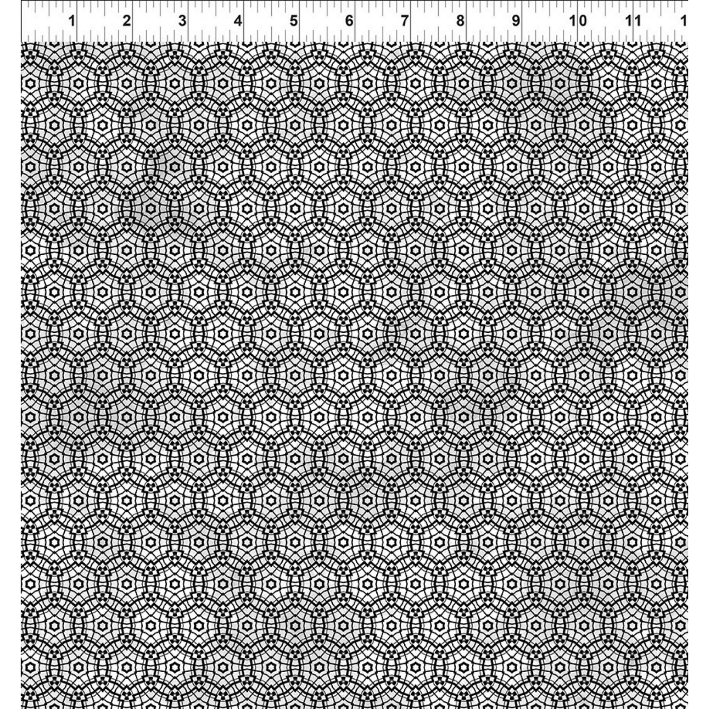 Geometric pattern of repeating circles and stars in simple black and metallic silver. Ruler for scale.