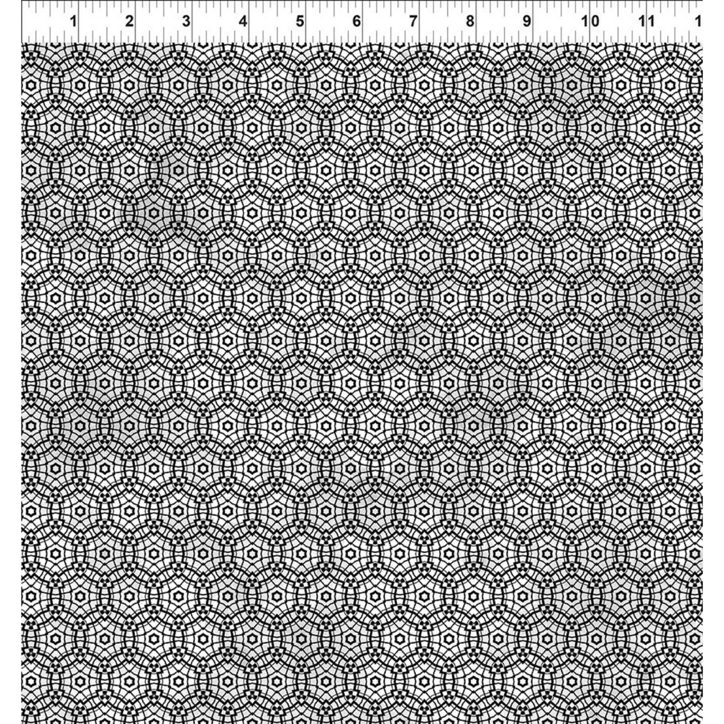 Geometric pattern of repeating circles and stars in simple black and metallic silver. Ruler for scale.