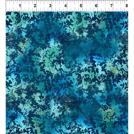 Blue and green abstract floral patterned fabric with a ruler for scale
