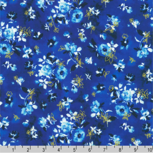 Blue, white, and gold flowers on a dark blue background with a ruler for scale