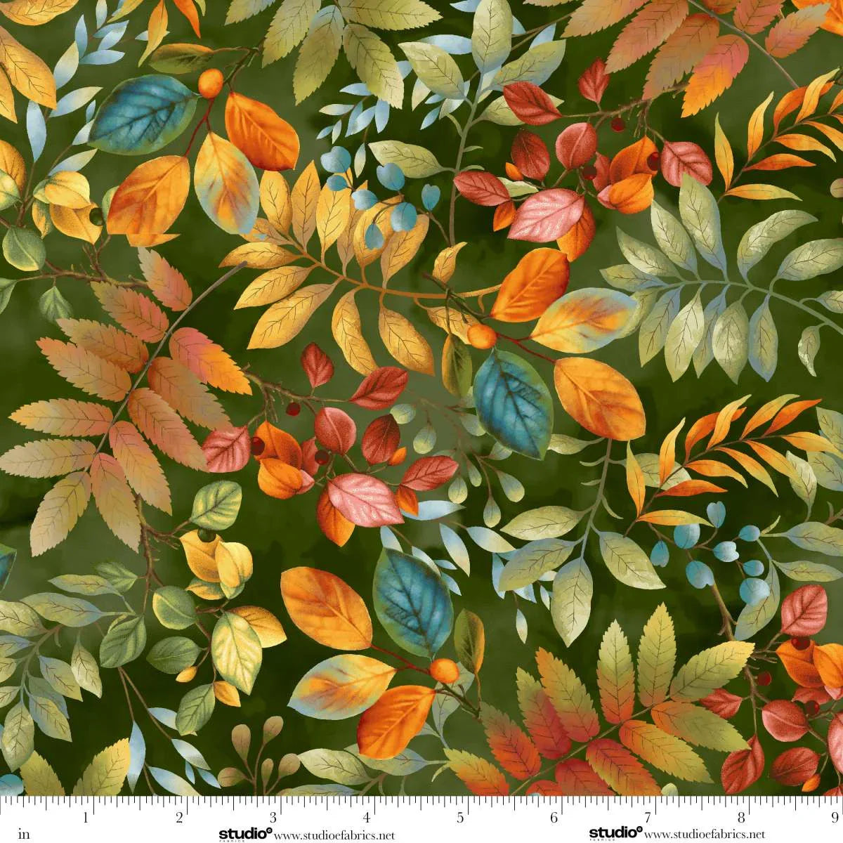 Fabric with autumn leaf pattern on a green background with a ruler at the bottom for scale.