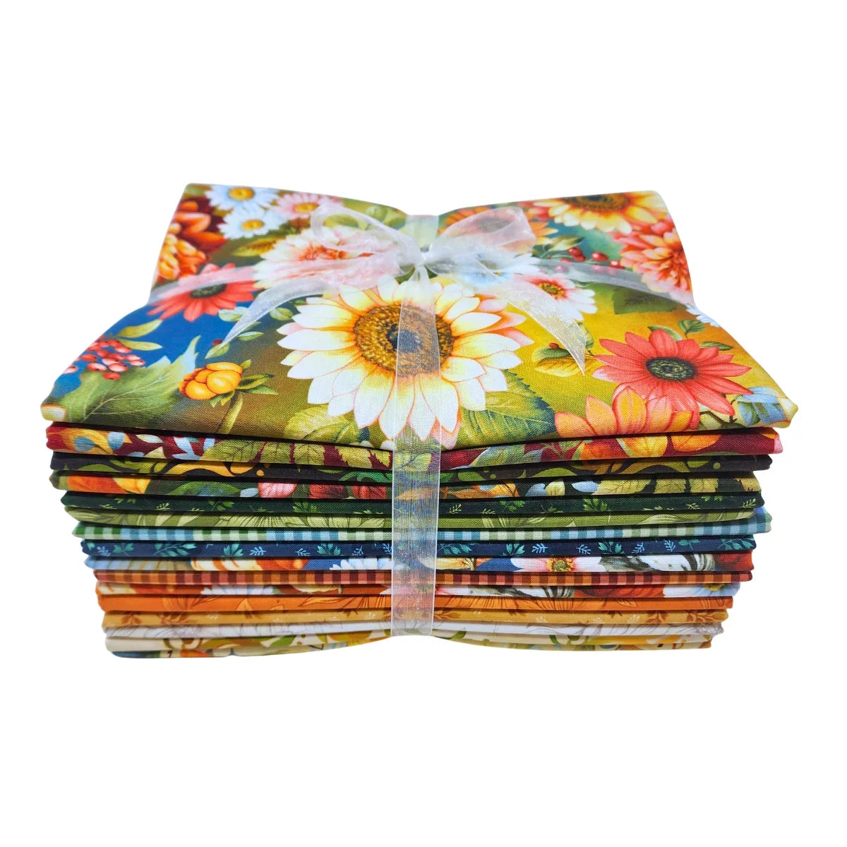 A stack of colorful fabric bundles tied together with a sheer white ribbon, featuring a vibrant floral and botanical print with sunflowers, daisies, and green leaves.