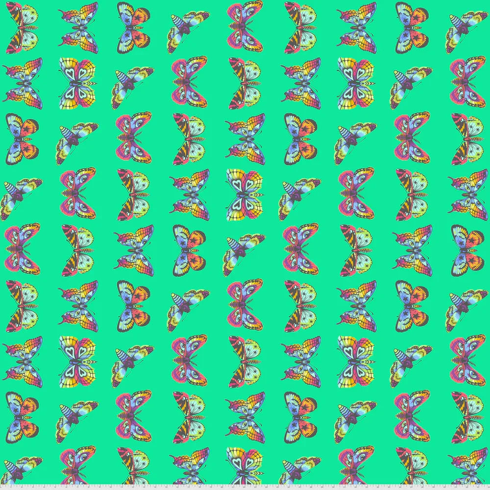 Pattern of colorful butterflies on a teal green background with a ruler for scale