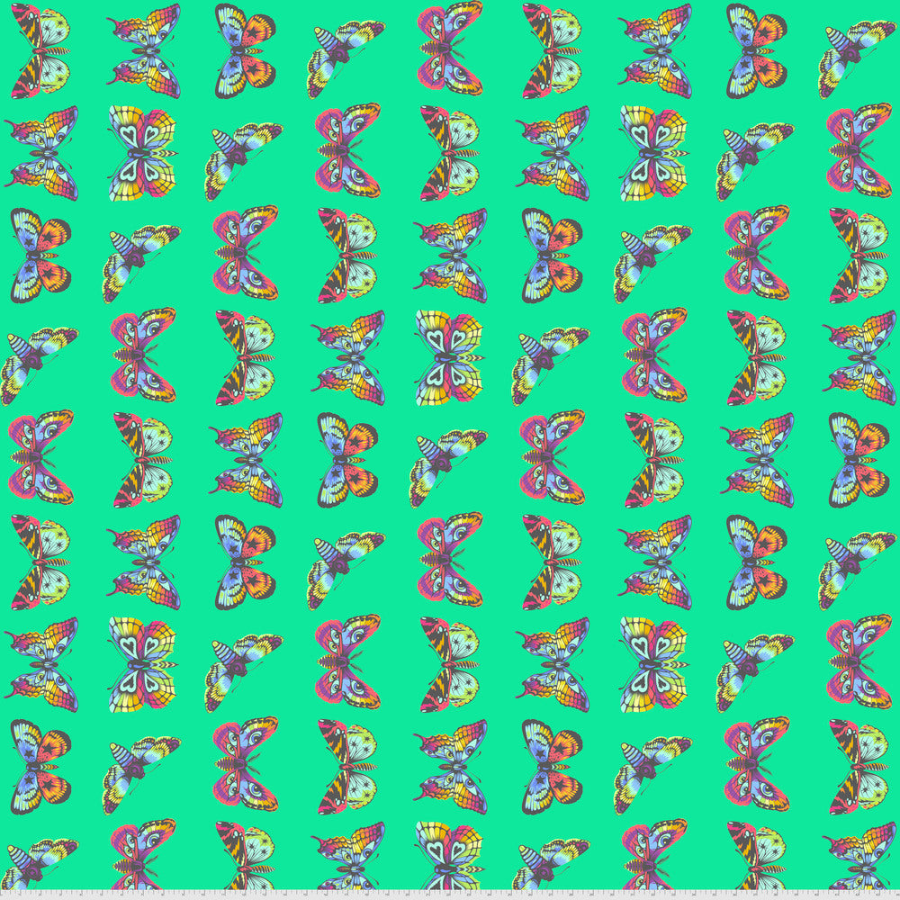 Pattern of colorful butterflies on a teal green background with a ruler for scale