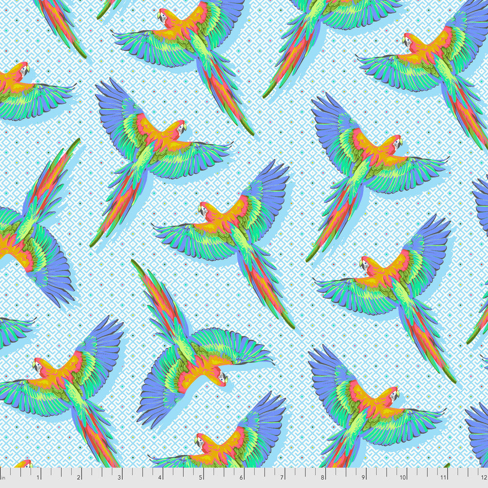 Pattern of colorful parrots on a light blue geometric background with a ruler for scale