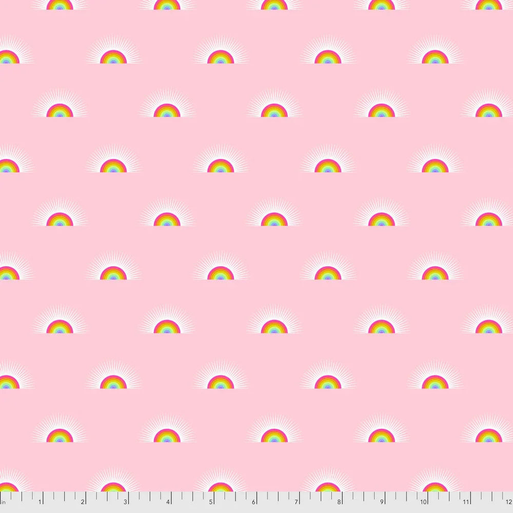 Pattern of rainbows arranged on a pink background with a ruler for scale