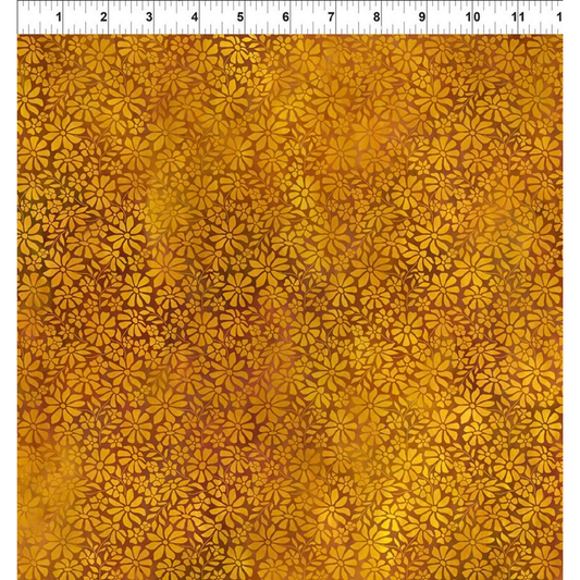 A fabric design featuring a lush meadow of daisy-like blooms, their petals layered in sumptuous warm amber and deep gold with a ruler at the top for scale.