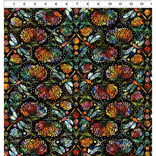 A repeating stained-glass-style floral and dragonfly pattern with orange, yellow, blue, green, and red sections outlined in black, arranged in a symmetrical decorative layout. Ruler at the top for scale.