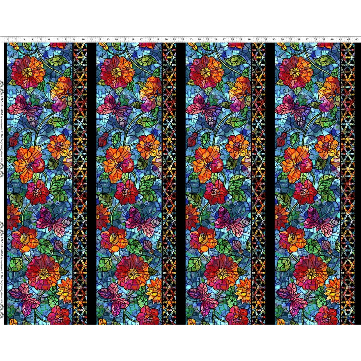 Fabric with four stripes featuring a repeating stained-glass-style floral pattern, large multicolored flowers, green leaves, butterflies, and narrow decorative borders, set against a blue background. Ruler across the top for scale.