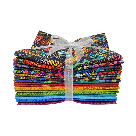 A stack of colorful fabric swatches featuring stained-glass floral designs tied with a white ribbon.