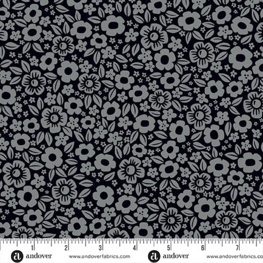 Floral pattern with small grey flowers on a black background with a ruler for scale