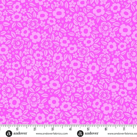 Pattern of dense pink cartoon flowers on a magenta background with a ruler for scale