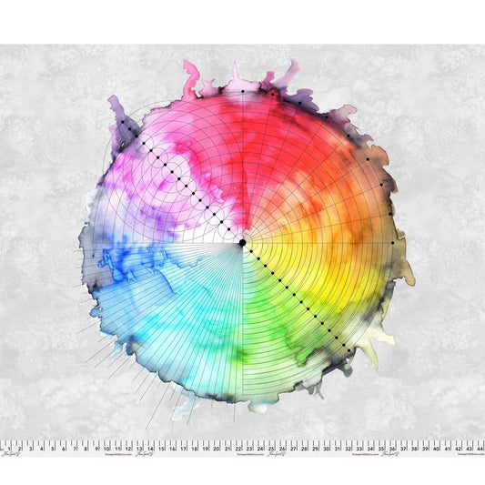 Color wheel with a blended gradient of colors on a textured grey background with a ruler at the bottom for scale.