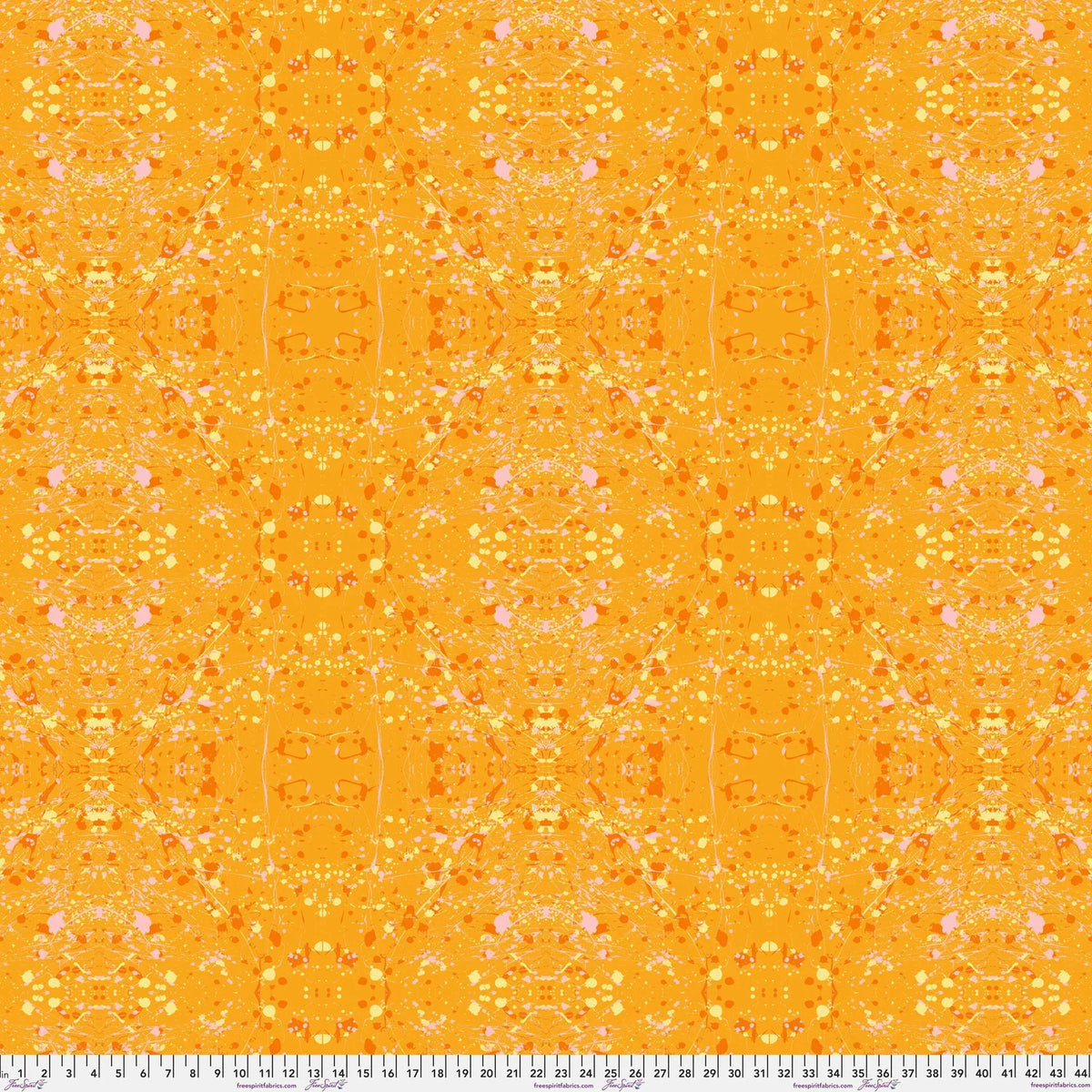A seamless repeating fabric pattern featuring a symmetrical, kaleidoscopic design in vibrant orange, yellow, and soft pink tones. Ruler at the bottom for scale.