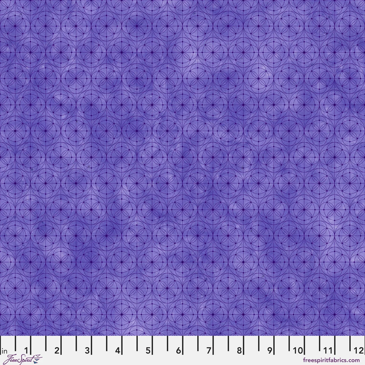 Purple fabric with a repeating geometric circle pattern, shown with a white ruler along the bottom edge for scale.