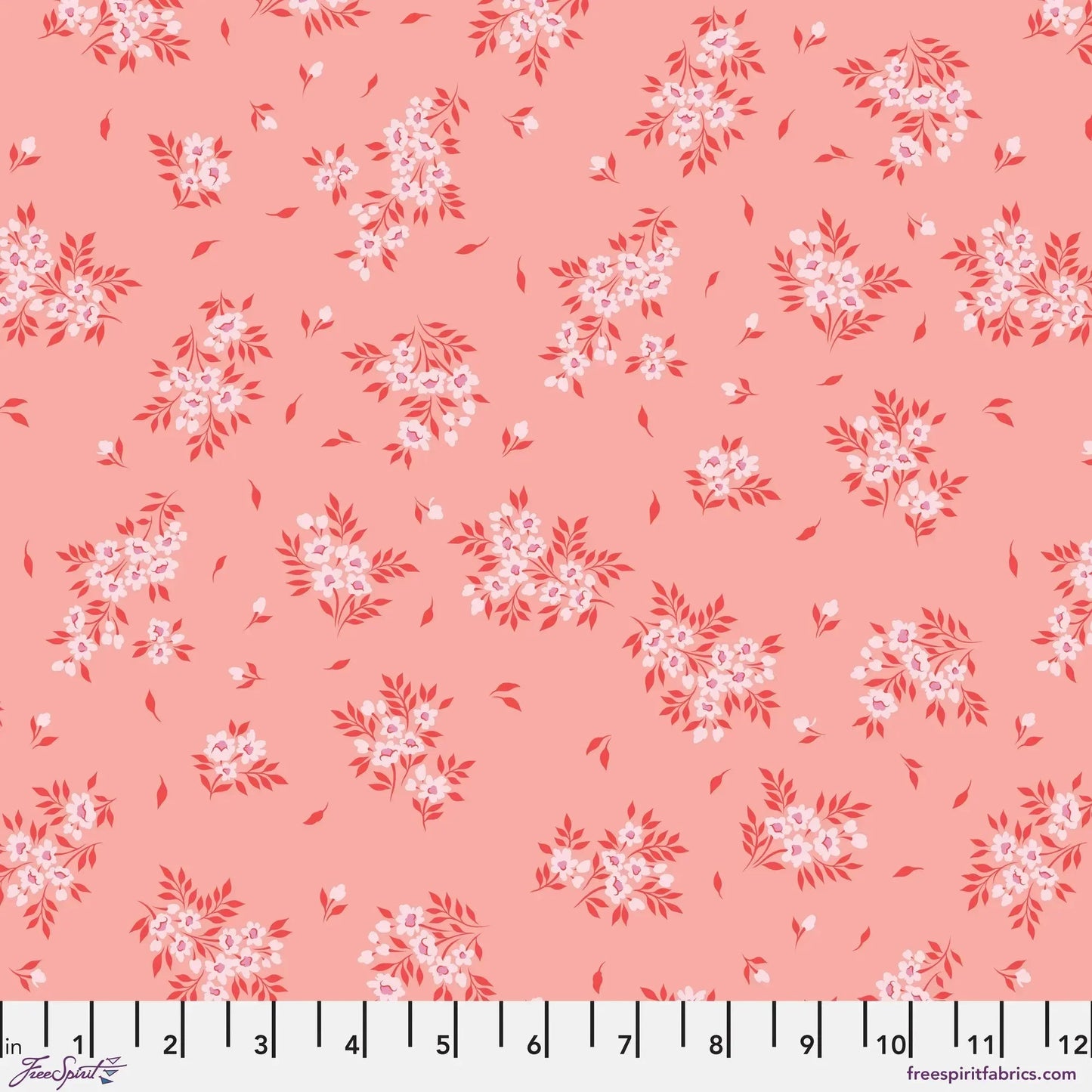 small sprays of light pink flowers scattered across a peach-pink background with a ruler for scale