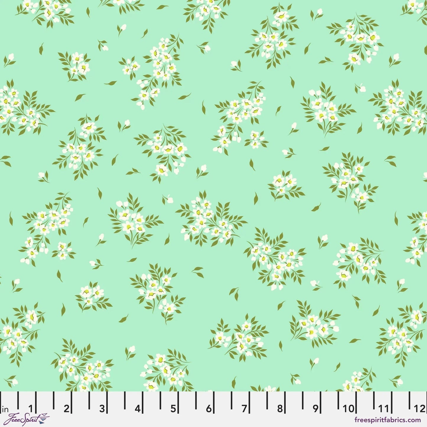 small sprays of white flowers scattered across a mint green background with a ruler for scale