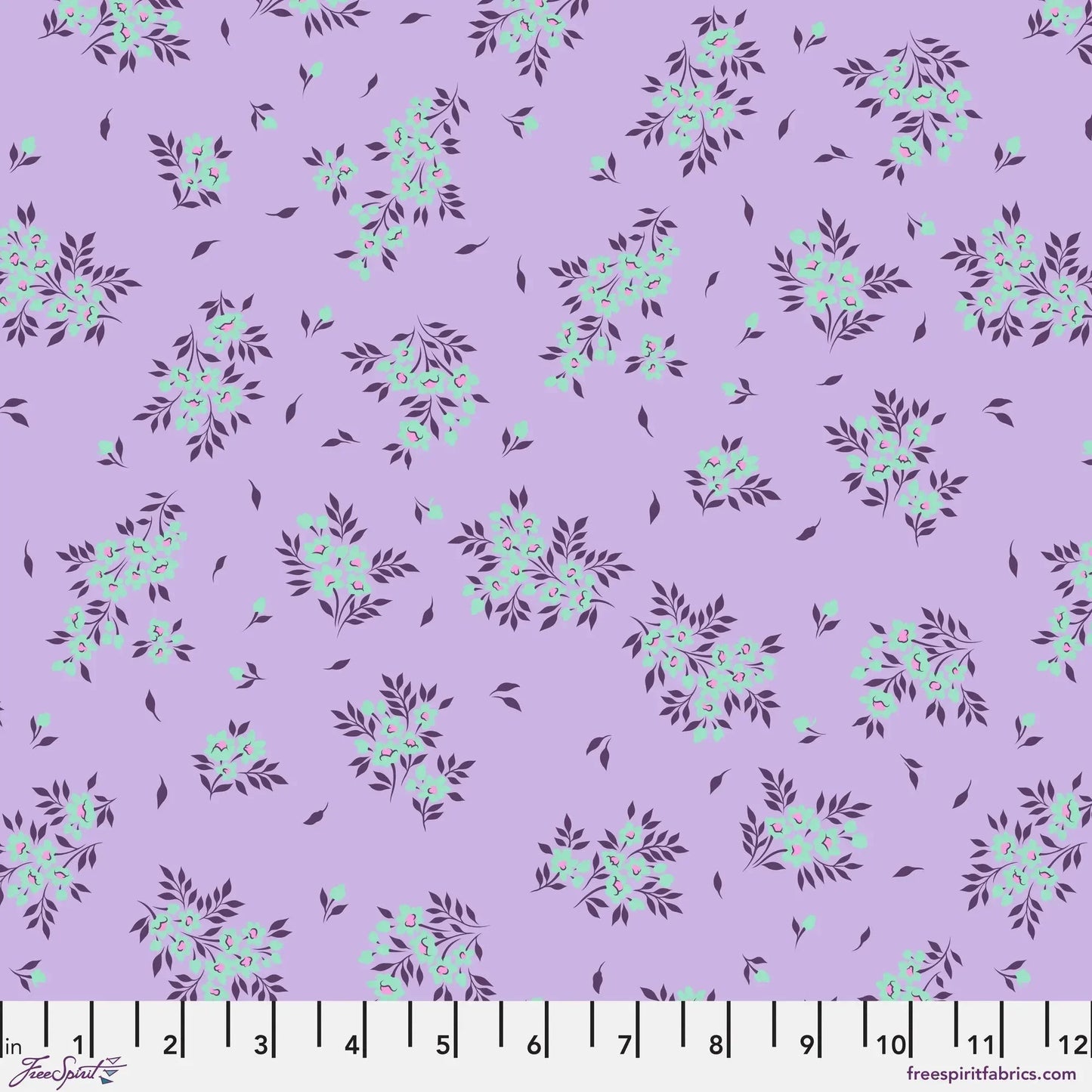 small sprays of aqua flowers scattered across a light purple background with a ruler for scale