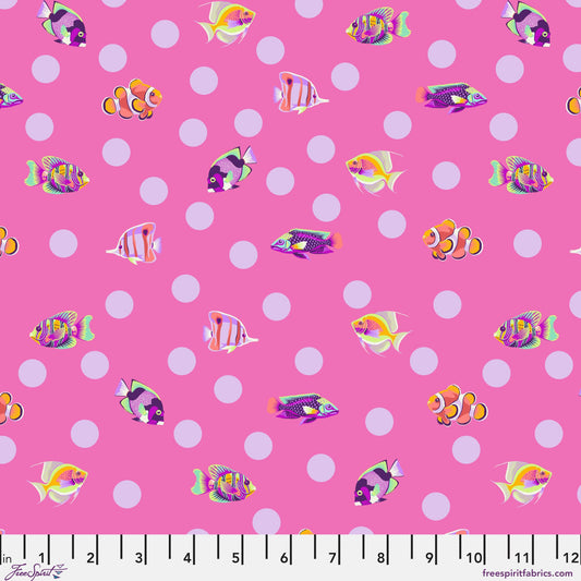 Pattern of colorful fish on a pink background with lavender polka dots. Ruler at the bottom for scale.