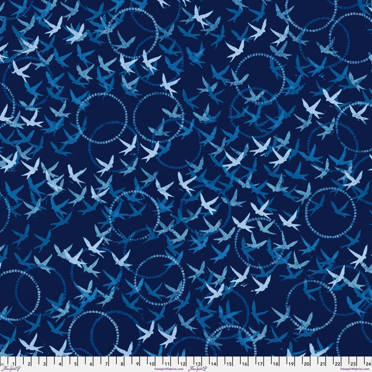 Pattern of white birds and blue circles on a dark blue background with a ruler for scale