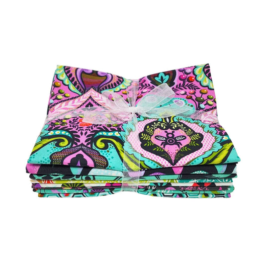 Stack of pink, teal, black, and white fabric squares tied with a white ribbon.