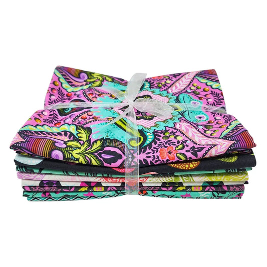 Stack of pink, teal, black, and white fabric squares tied with a white ribbon.