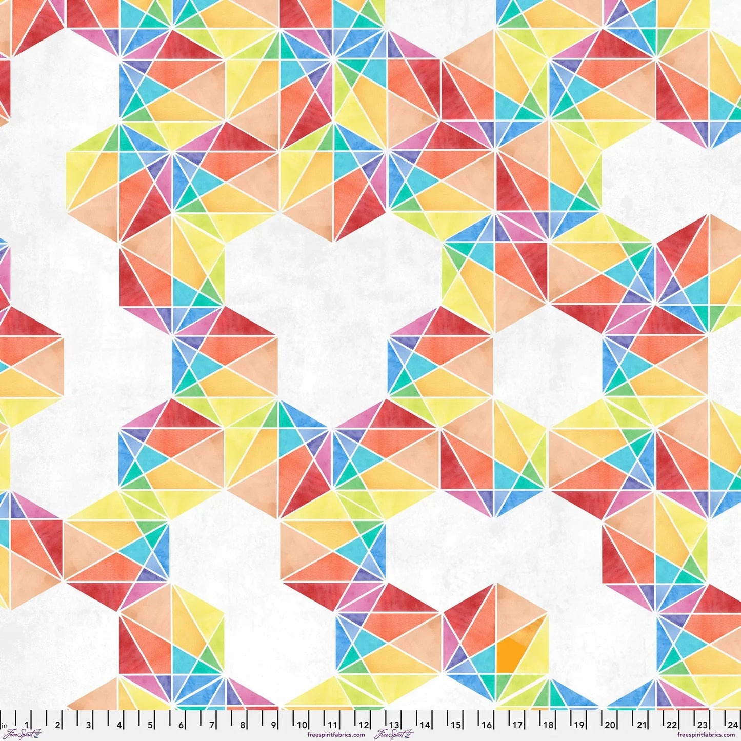 Fabric with a bold, graphic pattern of hexagons subdivided into vivid, multicolored triangles. Ruler at the bottom for scale.