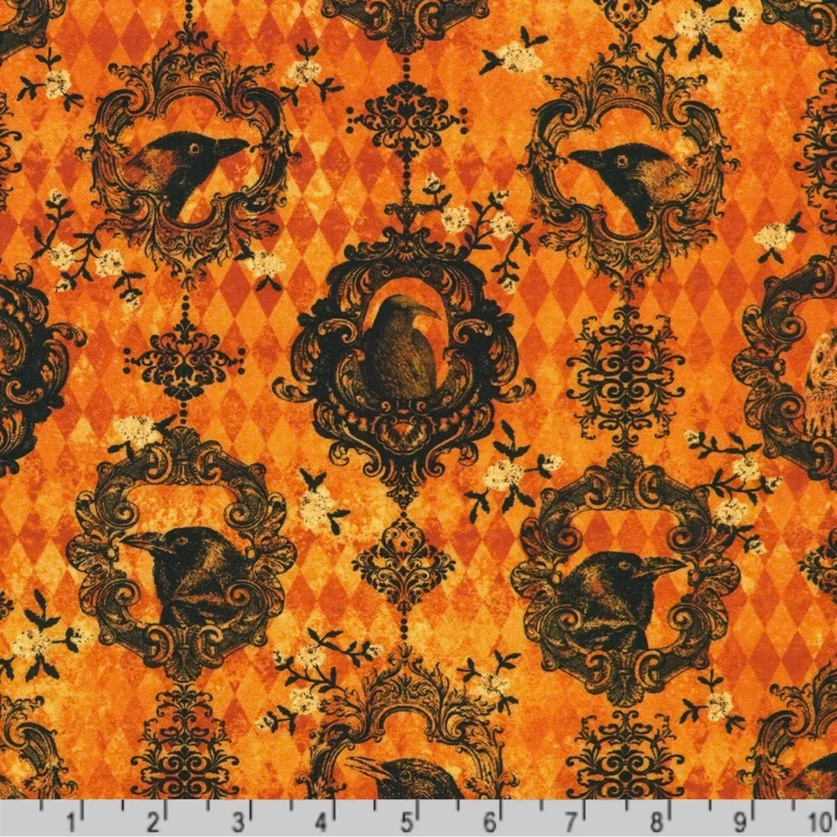 Fabric featuring black ravens and owls in ornate black scrollwork frames with small ivory floral accents on a burnt-orange harlequin diamond background. Ruler at the bottom for scale.