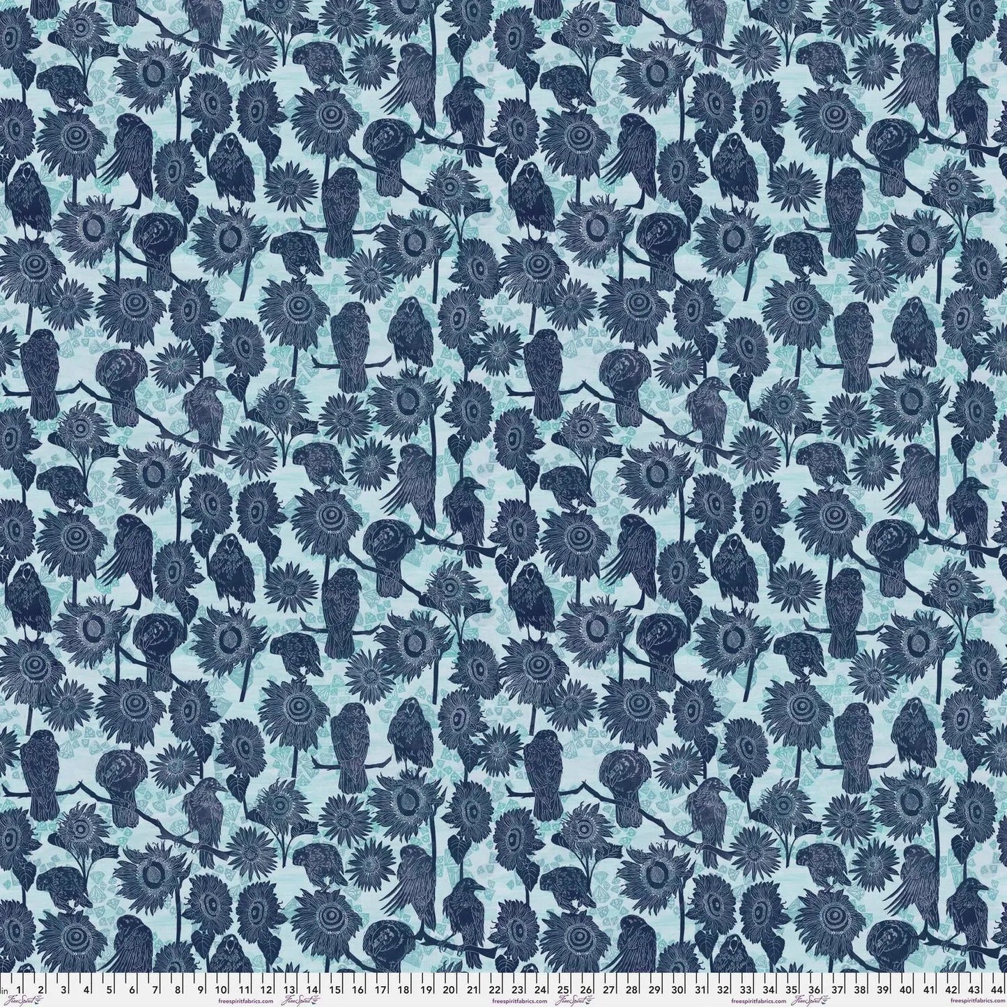 Pattern of navy blue birds and sunflowers on a powder blue background with a ruler for scale.