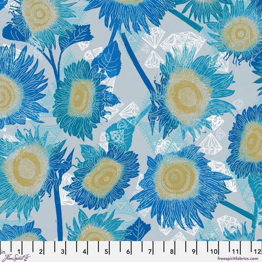 Pattern of blue and yellow flowers on a light blue background with a ruler at the bottom for scale.