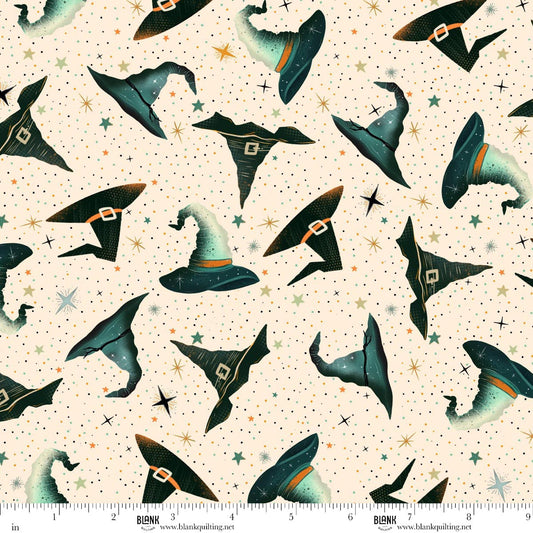 Pattern of witch hats on a beige background with stars. Ruler for scale.