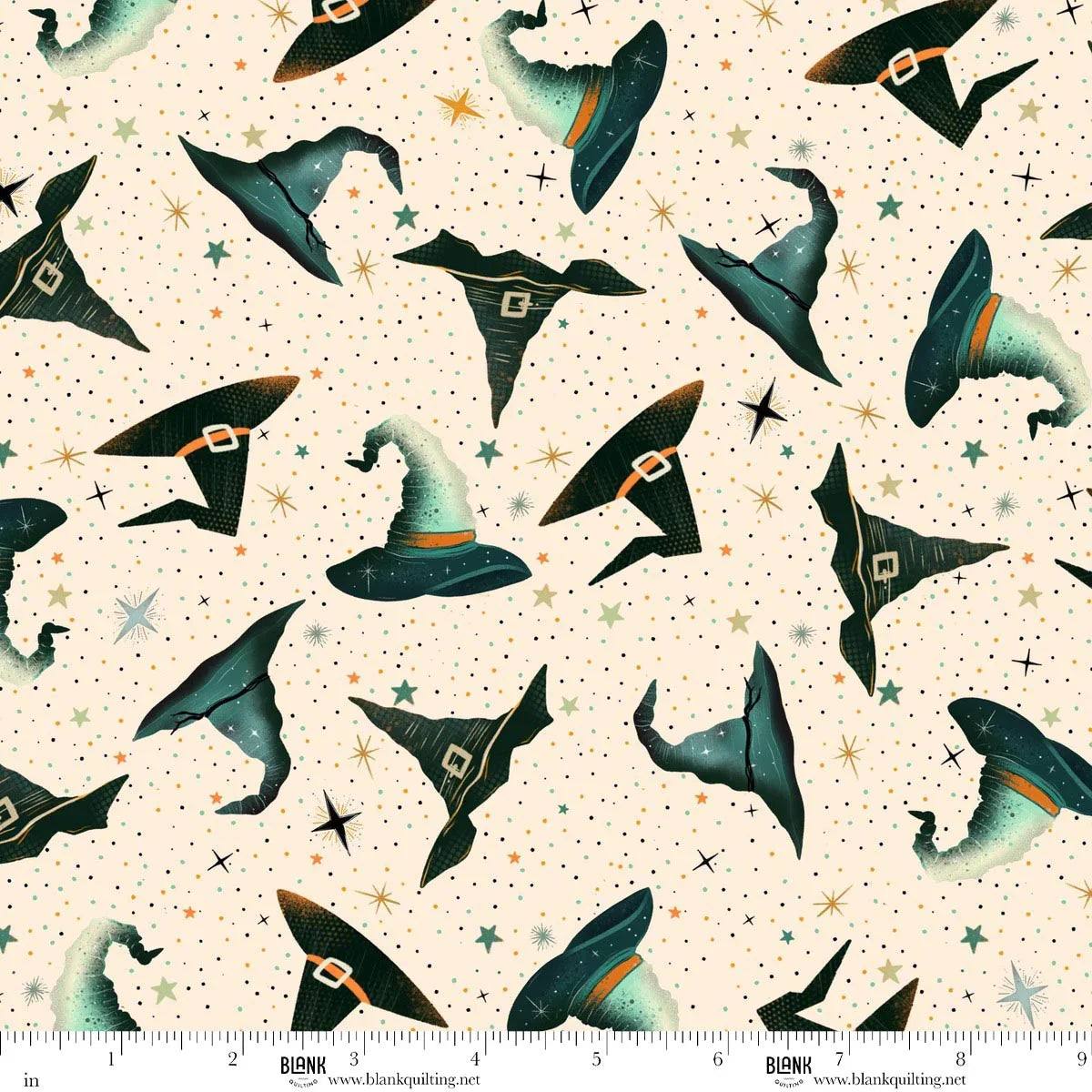 Pattern of witch hats on a beige background with stars. Ruler for scale.