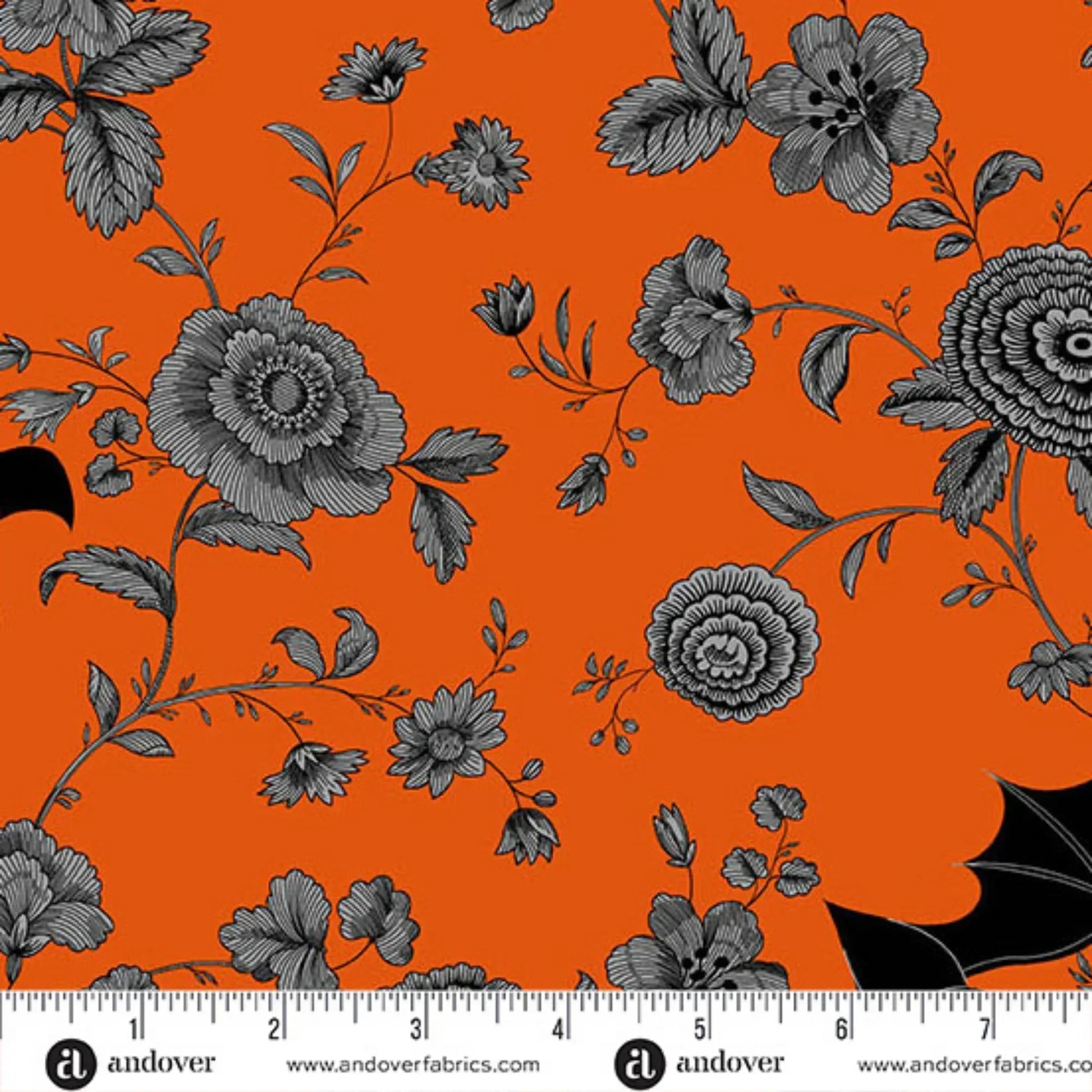 Black floral pattern on an orange background with black bats. Ruler for scale