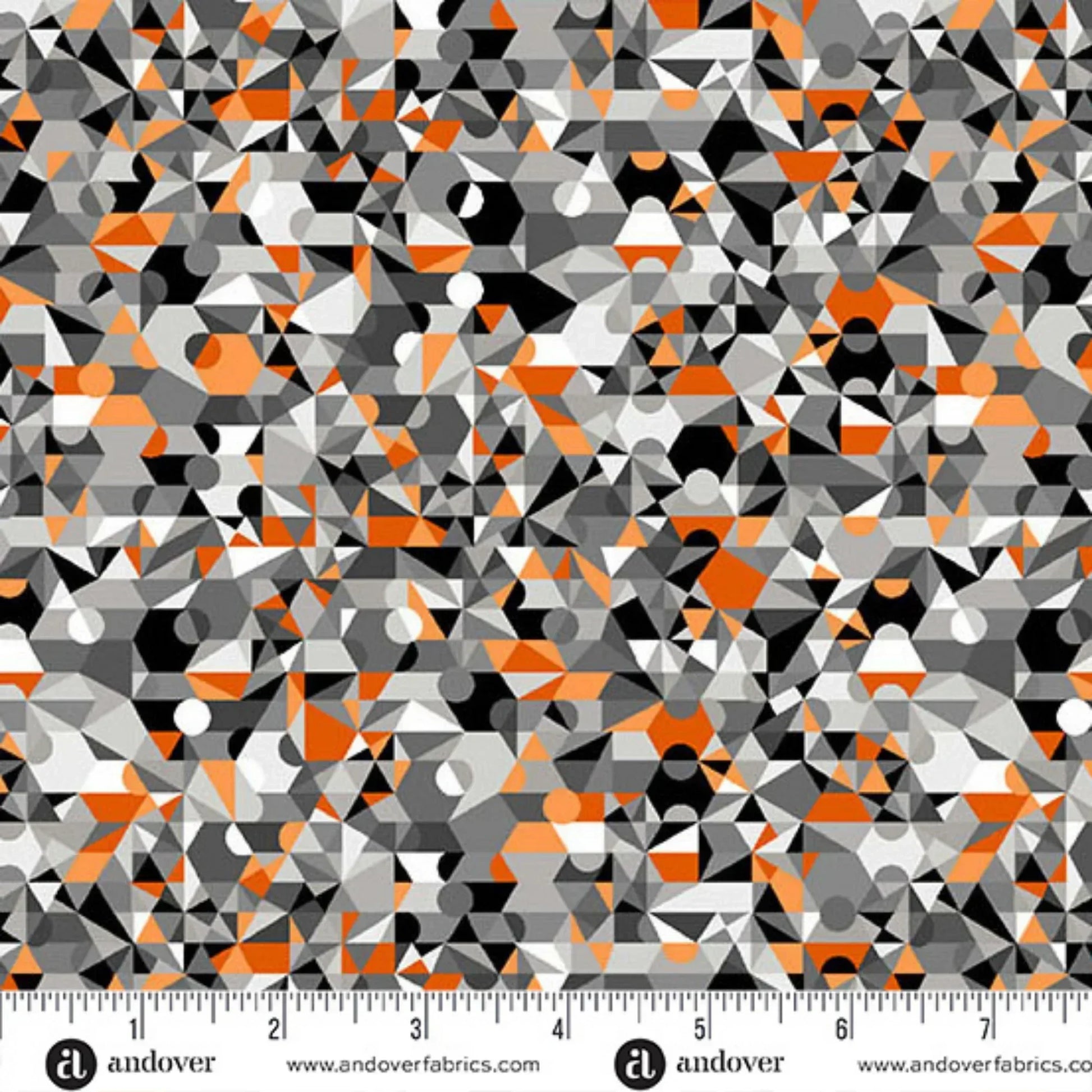 Geometric pattern fabric with a ruler at the bottom for scale, featuring orange, gray, and black colors.