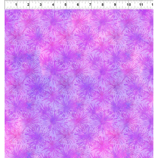 Patterned fabric with pink and purple starburst design and a ruler for scale