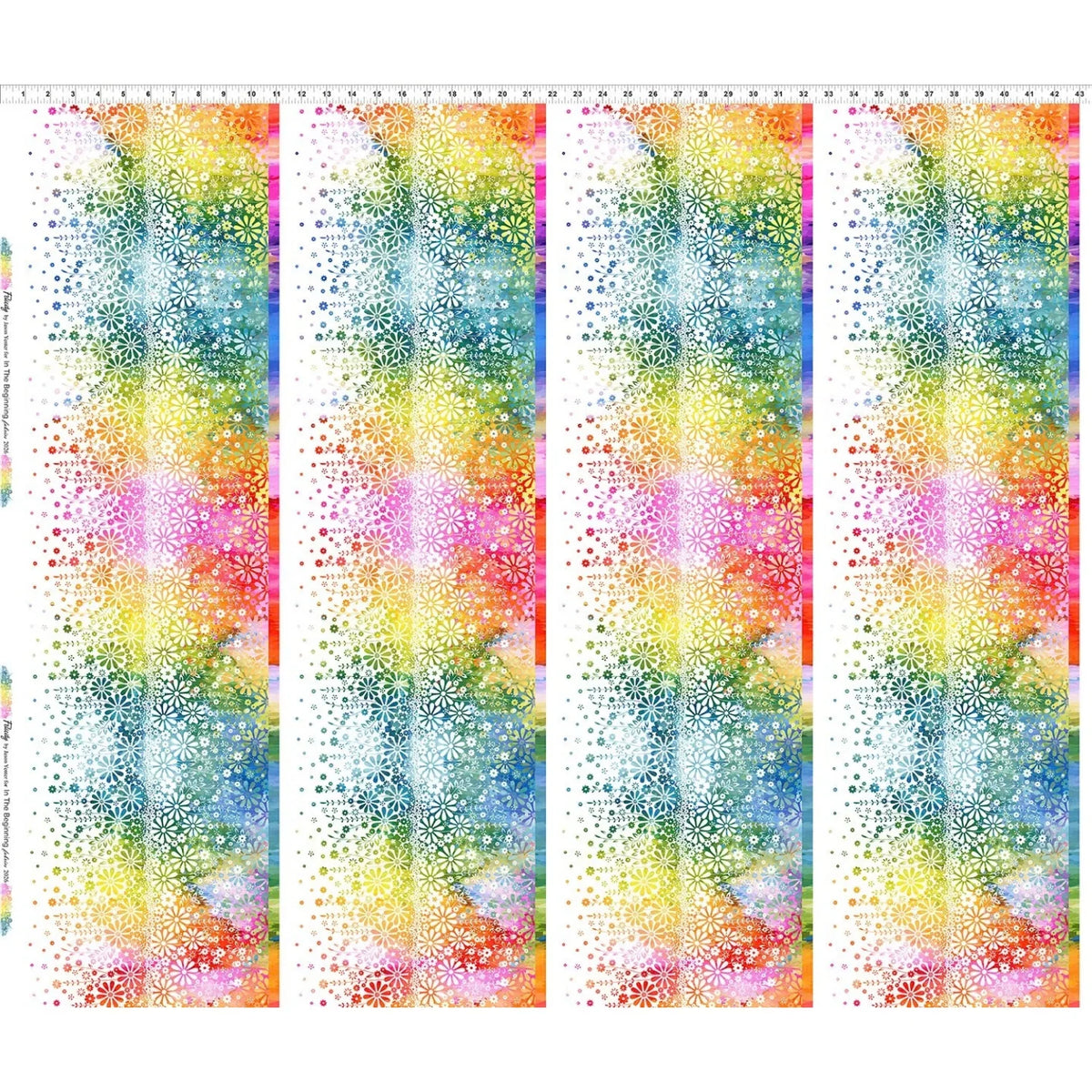 Fabric with four vertical stripes of colorful rainbow flowers, shown on a white background. Ruler along the top for scale.