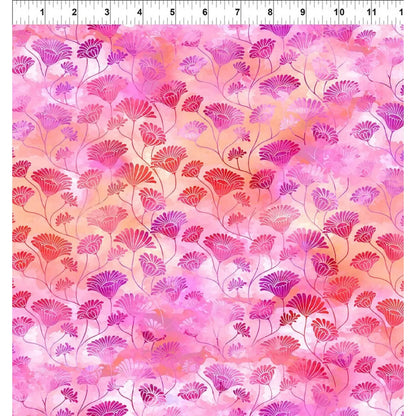 A fabric swatch featuring a repeating design of stylized pink, magenta, and red fan-shaped flowers on a watercolor-like pink and peach background, with a white ruler at the top indicating scale.