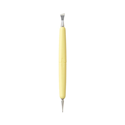 A dual-ended sewing tool with a pale yellow handle and silver metal tips, shown vertically on a plain white background.