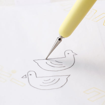 Yellow Hera tool tracing a bird outline on white paper