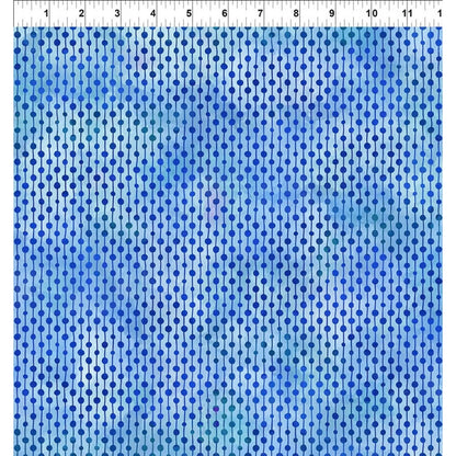Cobalt blue and aqua fabric with repeating dotted rows with a ruler at the top indicating scale.