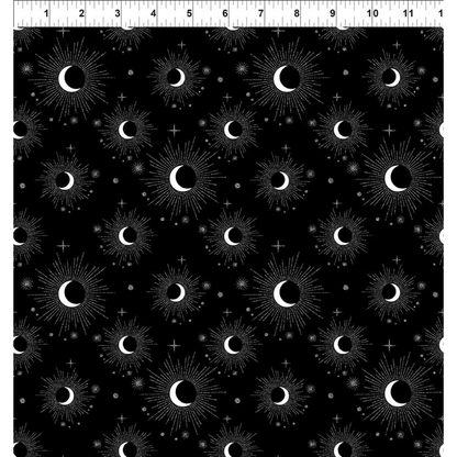 Pattern of white crescent moons and silver starbursts on a black background with a ruler for scale.