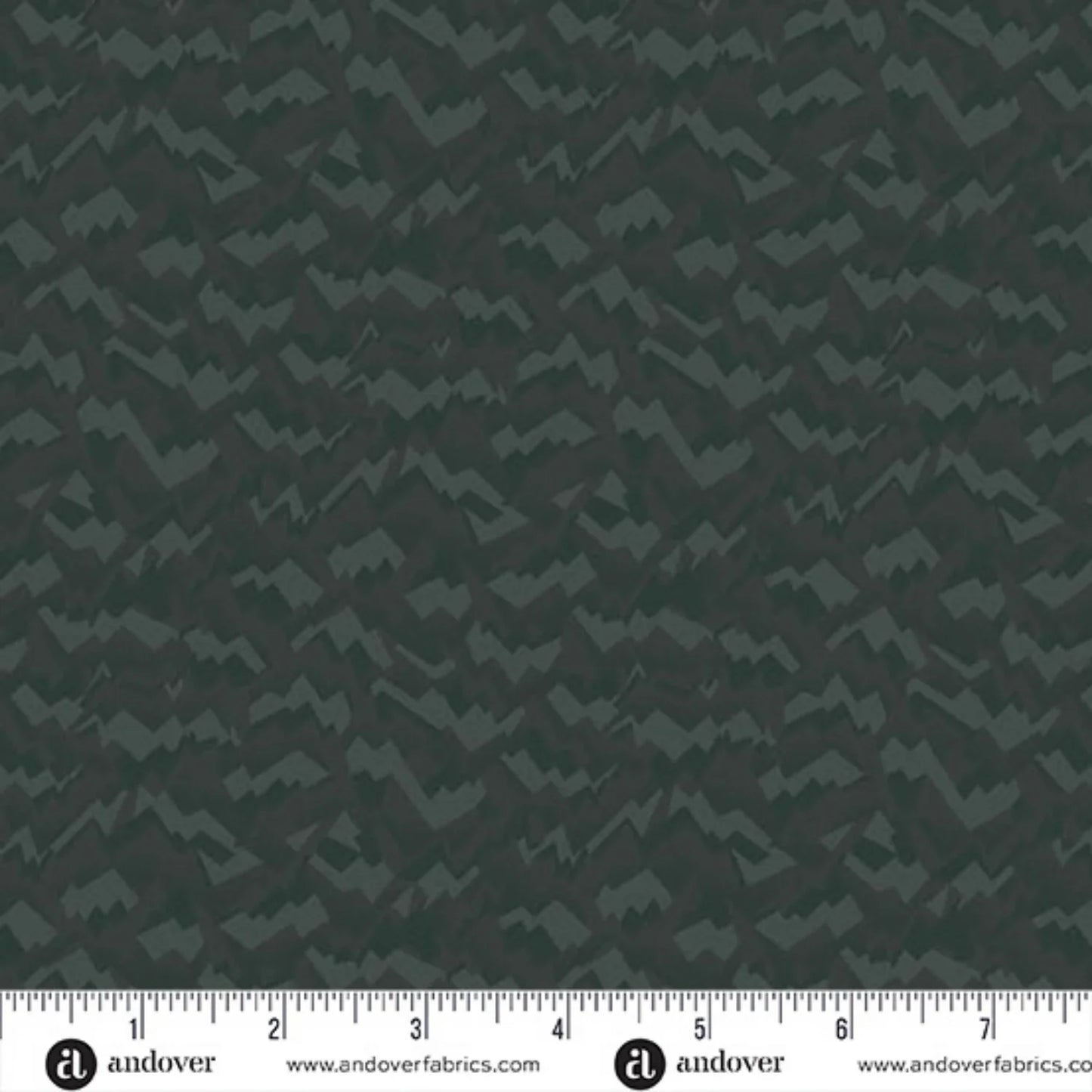 An abstract, fragmented and jagged pattern in layered tones of deep, nearly black forest green. Ruler at the bottom for scale.