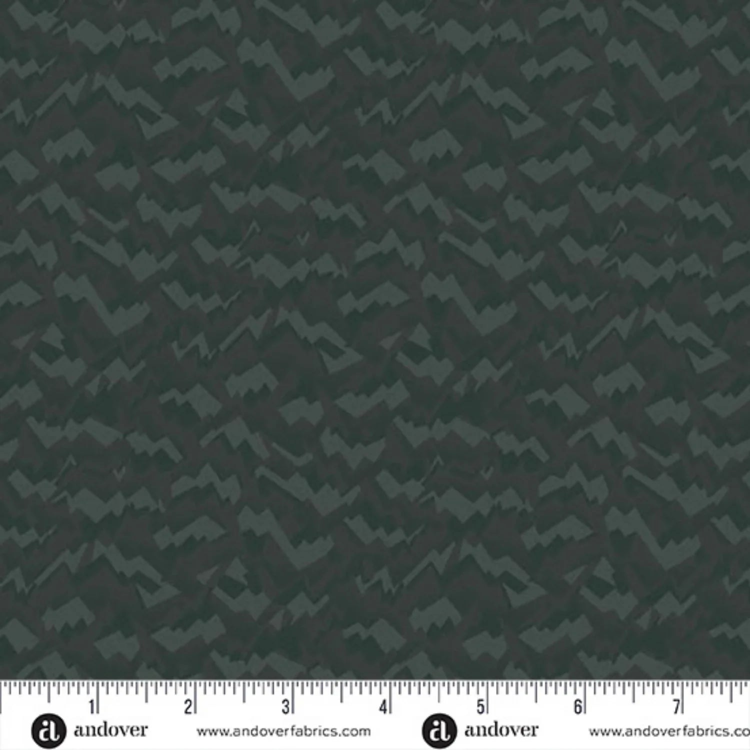 An abstract, fragmented and jagged pattern in layered tones of deep, nearly black forest green. Ruler at the bottom for scale.