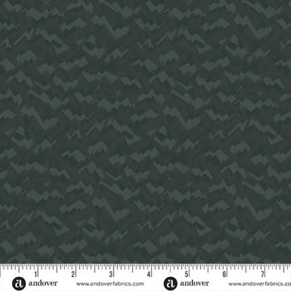 An abstract, fragmented and jagged pattern in layered tones of deep, nearly black forest green. Ruler at the bottom for scale.