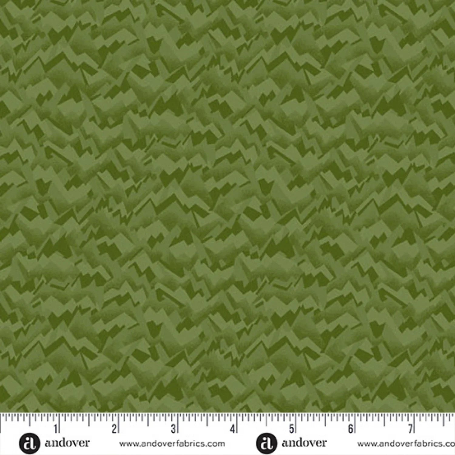 An abstract, fragmented and jagged texture in layered shades of pale olive, chartreuse, and evergreen. Ruler at the bottom for scale.