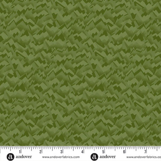 An abstract, fragmented and jagged texture in layered shades of pale olive, chartreuse, and evergreen. Ruler at the bottom for scale.