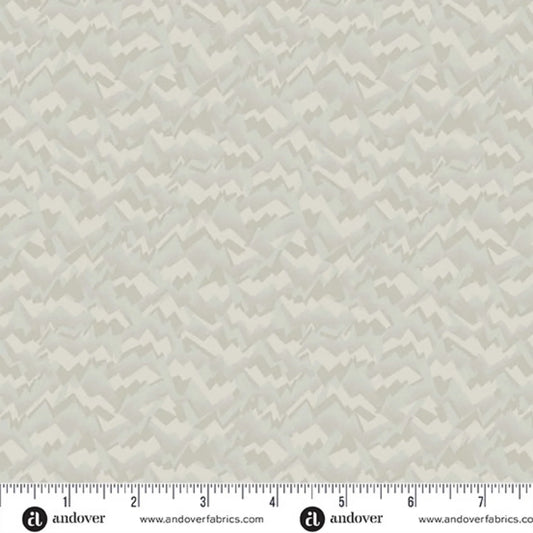 A fabric swatch featuring an abstract, fragmented, and jagged texture in layered shades of soft birch grey, smoky taupe, and warm cream. Ruler at the bottom for scale.