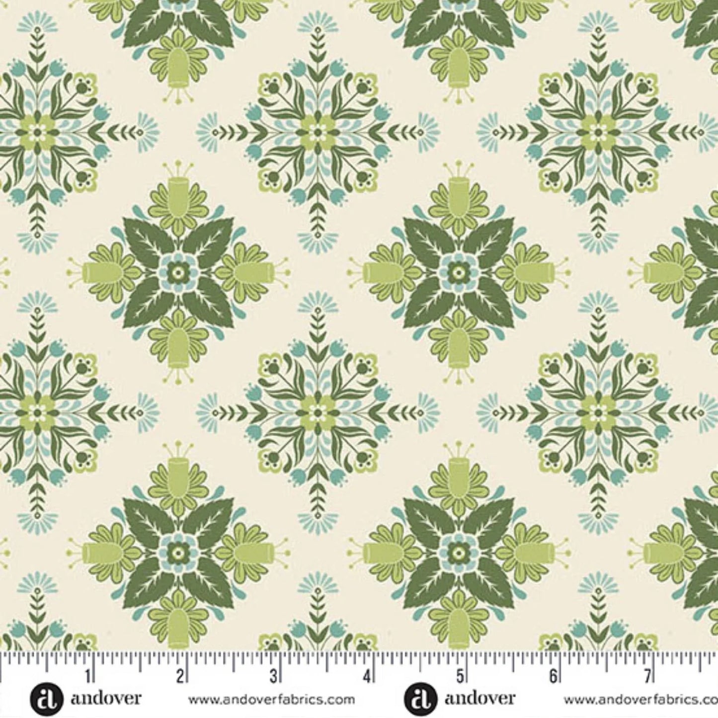A repeating fabric pattern featuring a bold, symmetrical folk art medallion design with intricate floral and leaf motifs in soft sage, teal, and dark green on a warm cream background. Ruler at the bottom for scale.