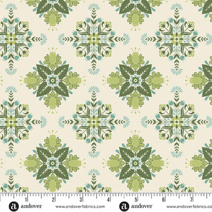 A repeating fabric pattern featuring a bold, symmetrical folk art medallion design with intricate floral and leaf motifs in soft sage, teal, and dark green on a warm cream background. Ruler at the bottom for scale.